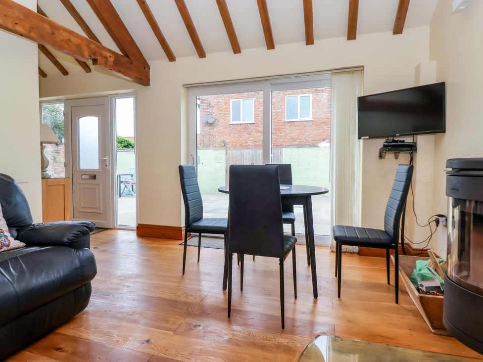 A dining room with a table and chairs at The Owl Barn Cottage 