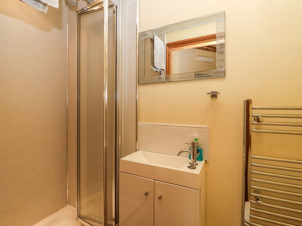 A bathroom with a shower and sink at The Owl Barn Cottage