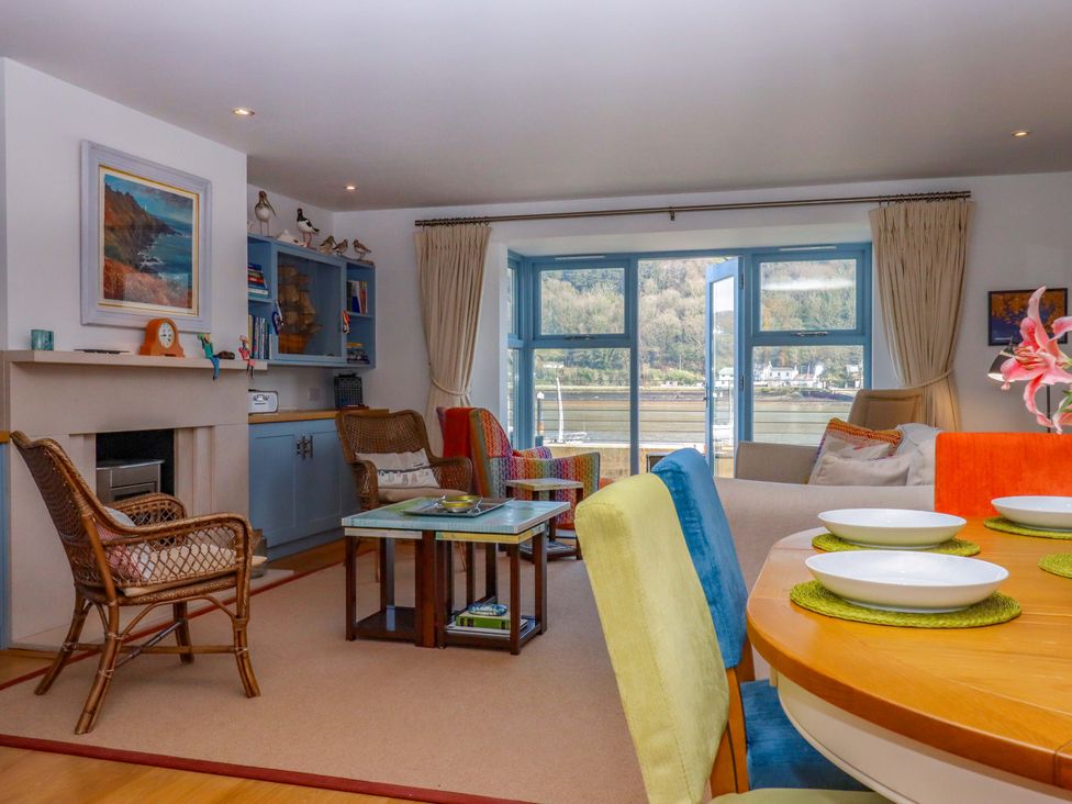 A living room with a sofa, coffee table, and dining area at 26 Dart Marina