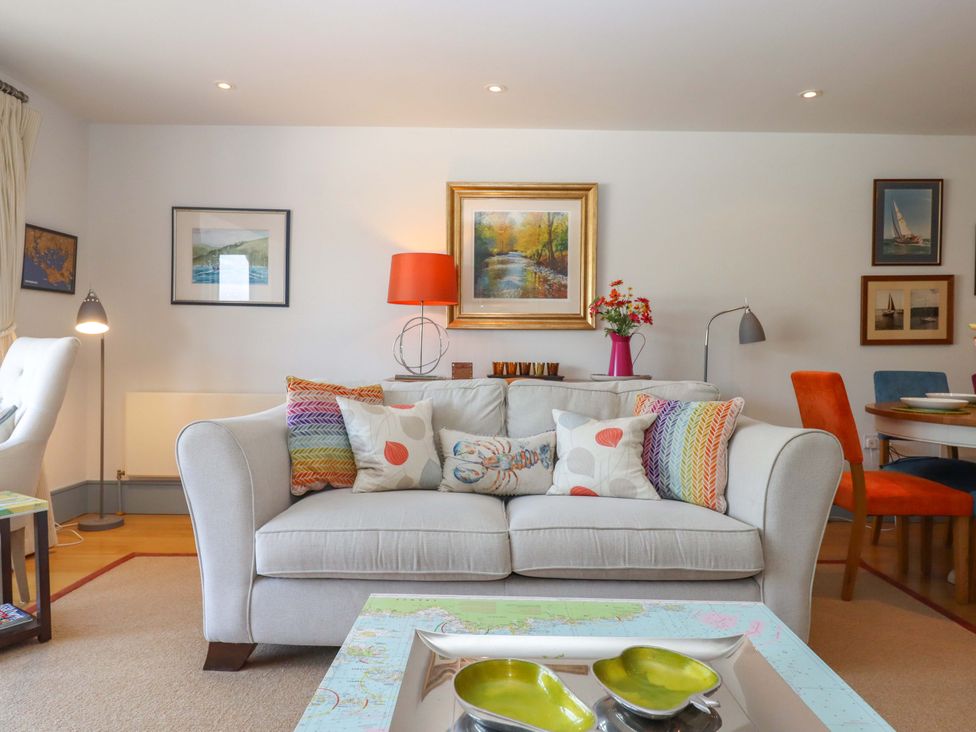 A living room with a sofa and coffee table at 26 Dart Marina