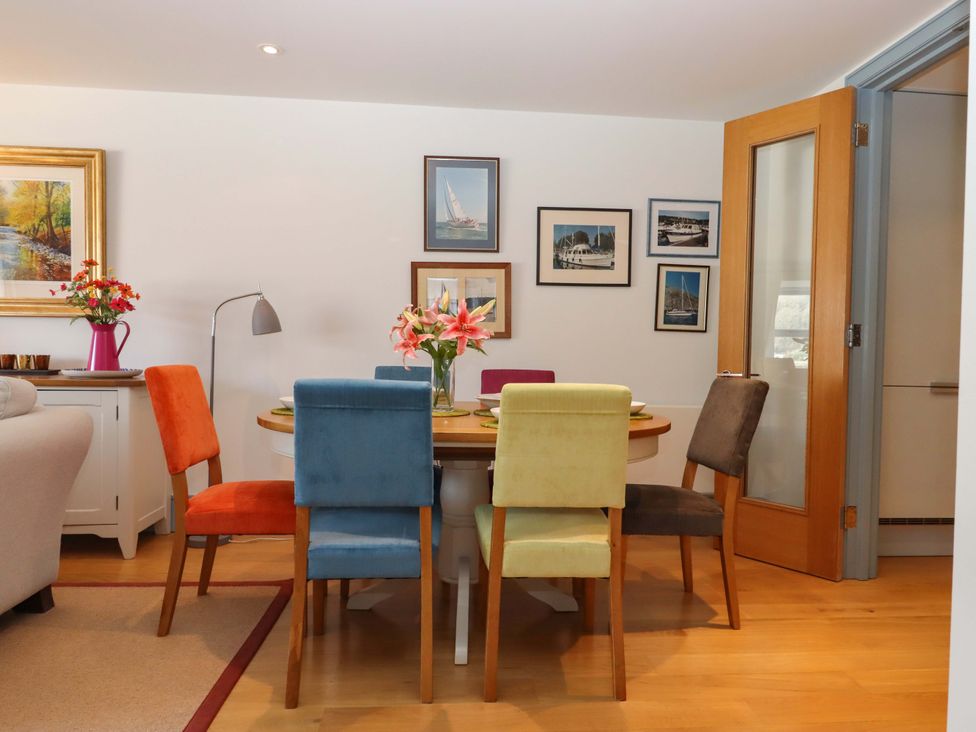 A dining room with a table and chairs at 26 Dart Marina