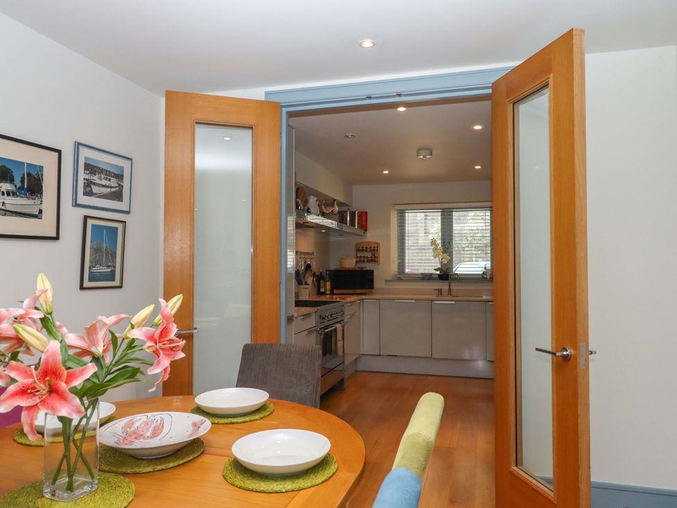 A kitchen with dining table and chairs at 26 Dart Marina