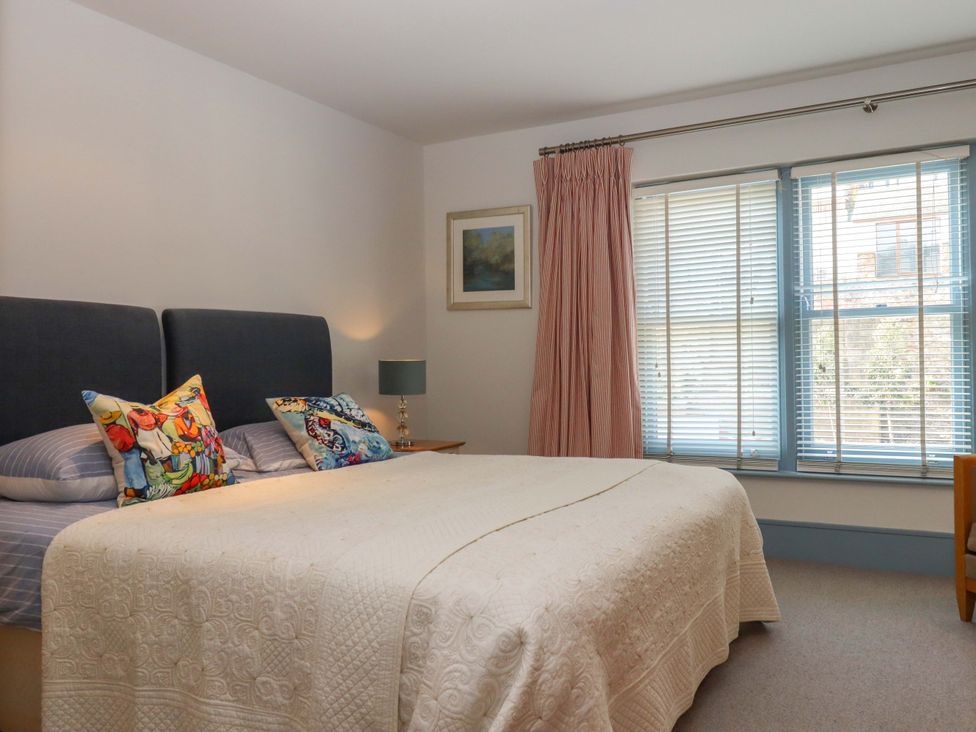 A bedroom with a bed and window at 26 Dart Marina