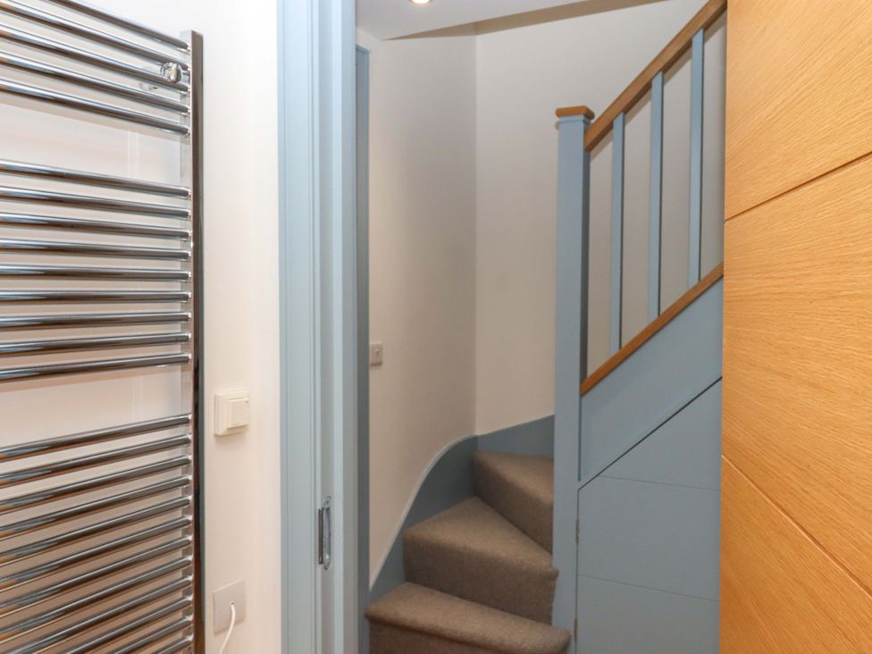 A staircase with a towel radiator at 26 Dart Marina
