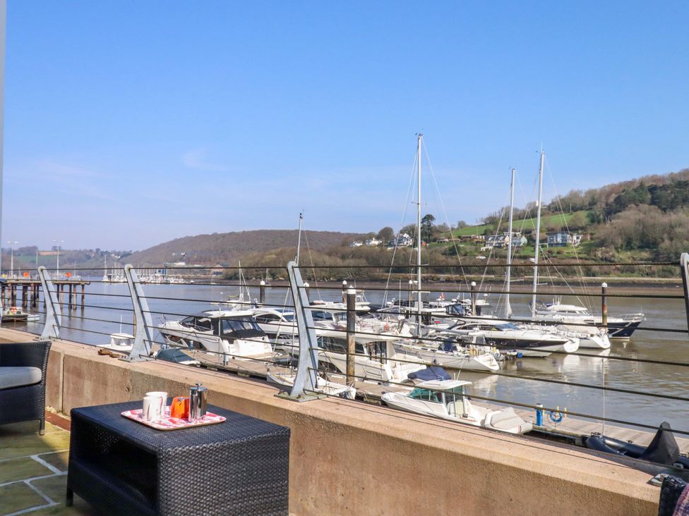 A view of boats and water from a patio at 26 Dart Marina