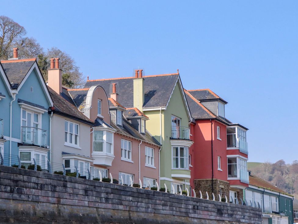 Houses with balconies along the waterfront at 26 Dart Marina