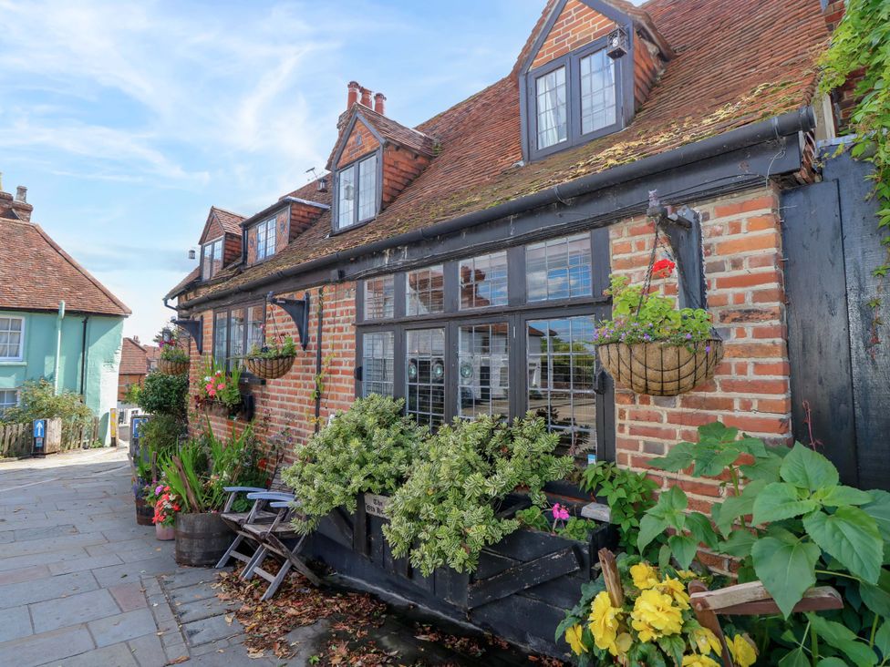 An outdoor view of a brick house with flower pots at The Old House in Hamble