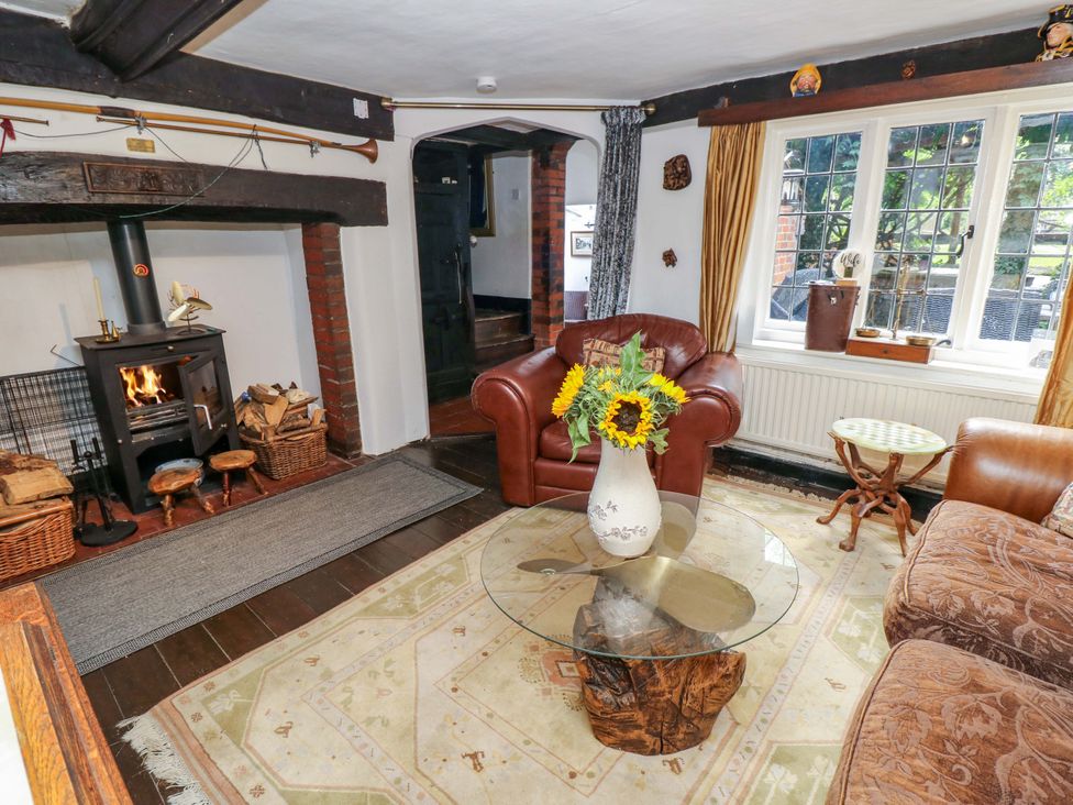 A living room with a fireplace and a sofa at The Old House in Hamble