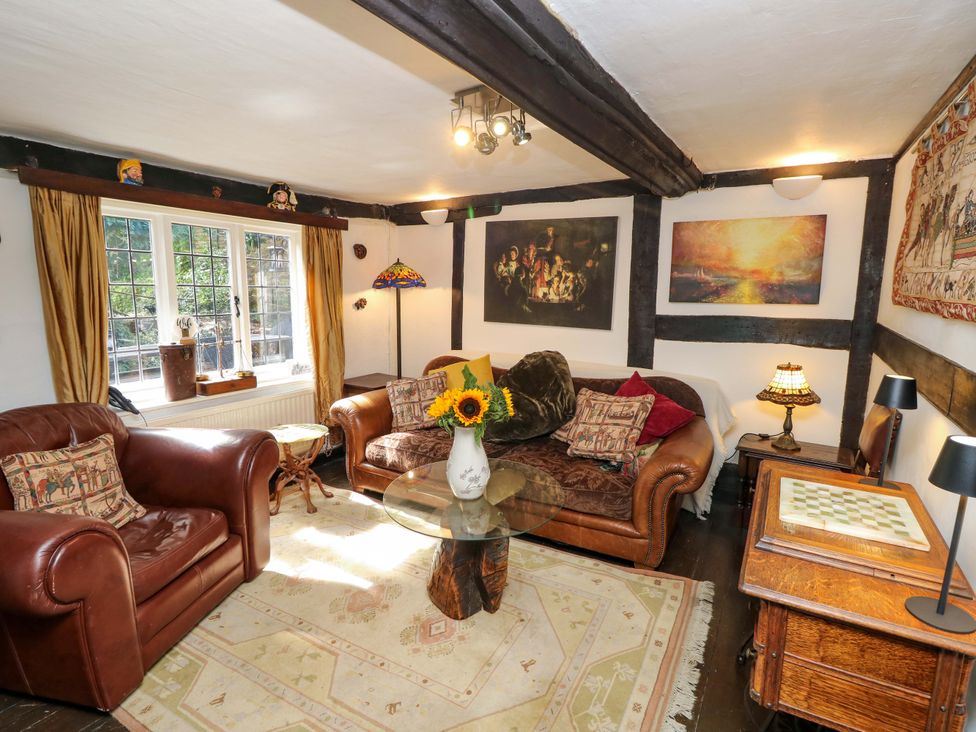 A living room with a sofa and armchair at The Old House in Hamble