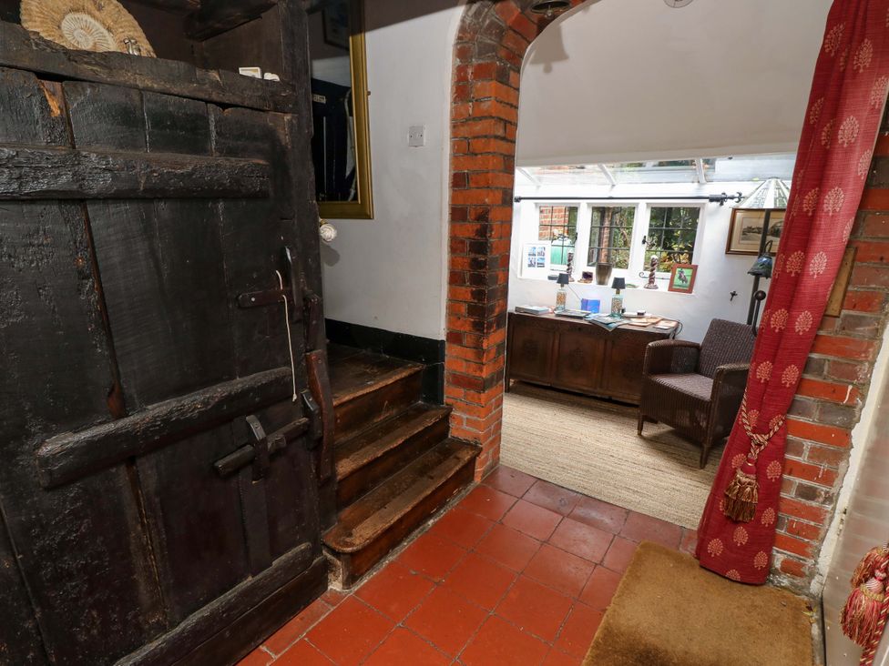 A hallway with a wooden door and stairs at The Old House in Hamble