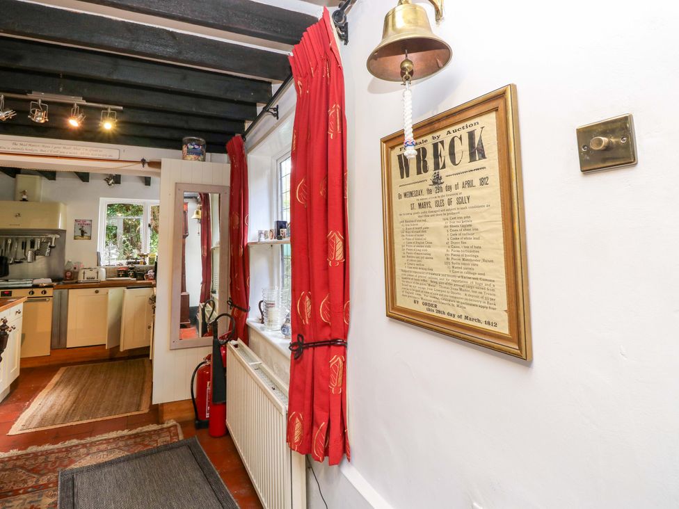 A kitchen with a mirror and a fire extinguisher at The Old House in Hamble