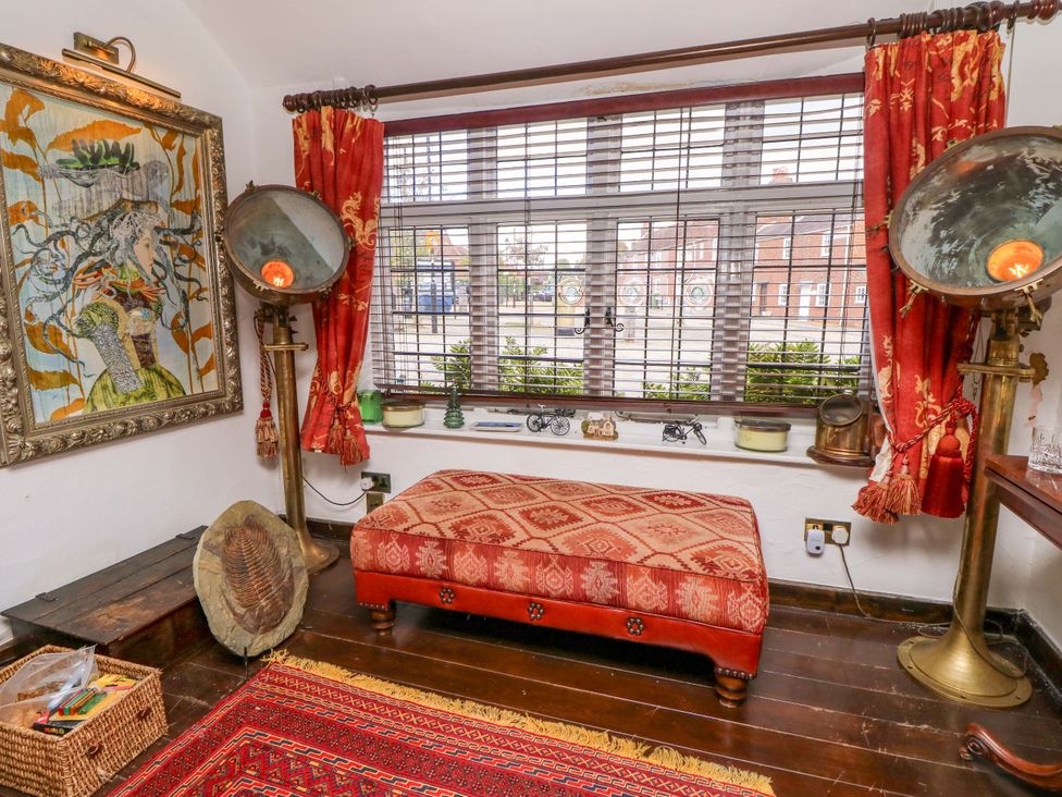 A sitting room with a painting and footstool at The Old House in Hamble