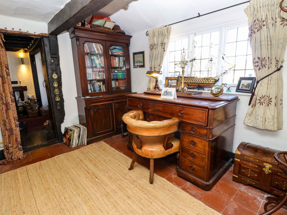 A study with a desk and bookshelves at The Old House in Hamble