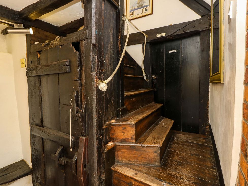 A staircase with wooden steps and a door at The Old House in Hamble