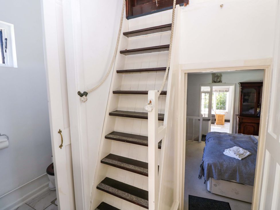 A staircase leading to an upper level and view of a bedroom at The Old House in Hamble