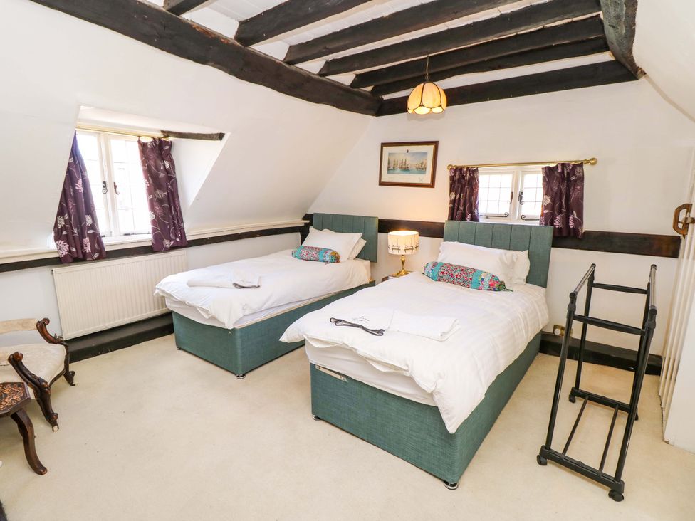A bedroom with two single beds and a lamp at The Old House in Hamble