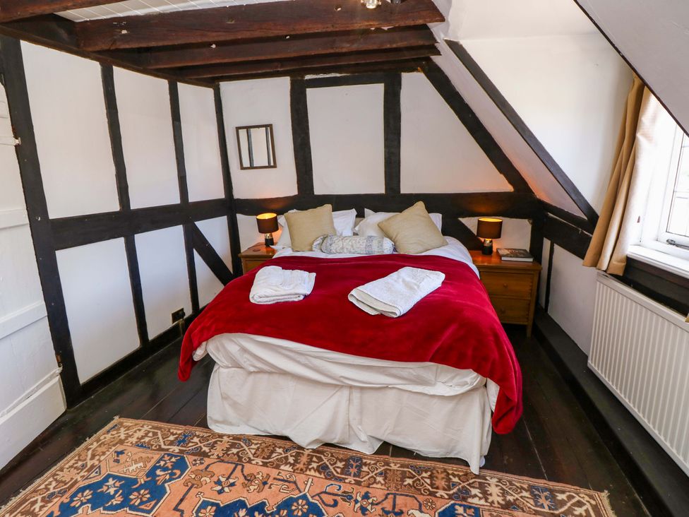 A bedroom with a bed and nightstand at The Old House in Hamble
