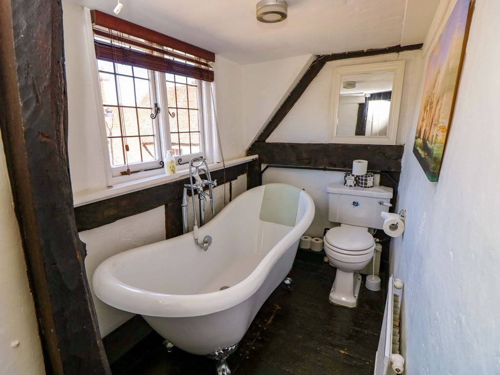 A bathroom with a bathtub and toilet at The Old House in Hamble