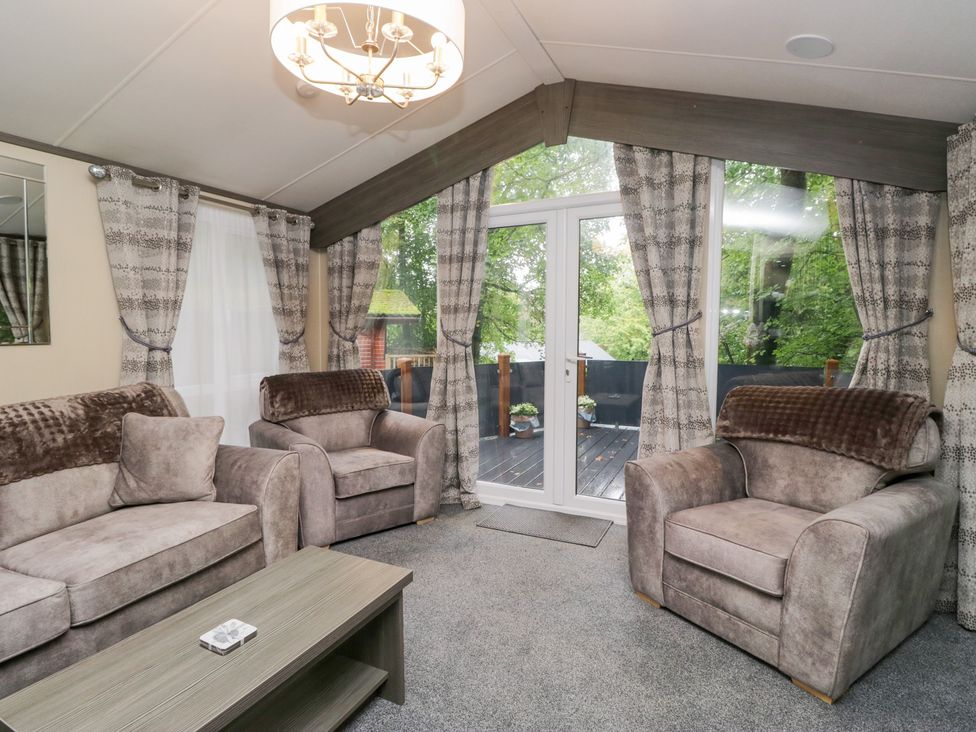 A living room with sofas and a coffee table at Feather Hill Lodge in Windermere