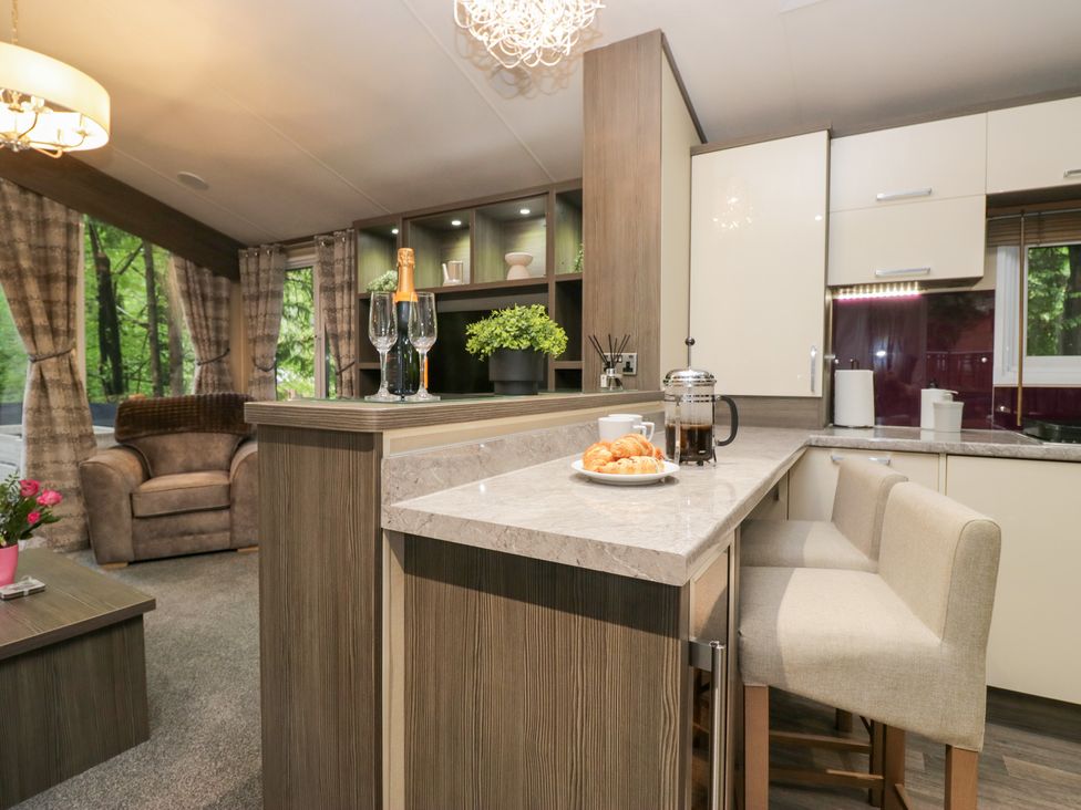 A kitchen with bar stools and breakfast items at Feather Hill Lodge in Windermere