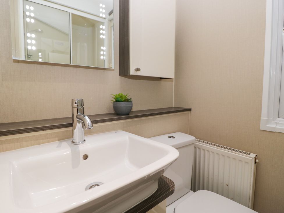 A bathroom with a sink and toilet at Feather Hill Lodge in Windermere