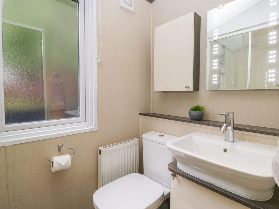A bathroom with a sink and toilet at Feather Hill Lodge in Windermere