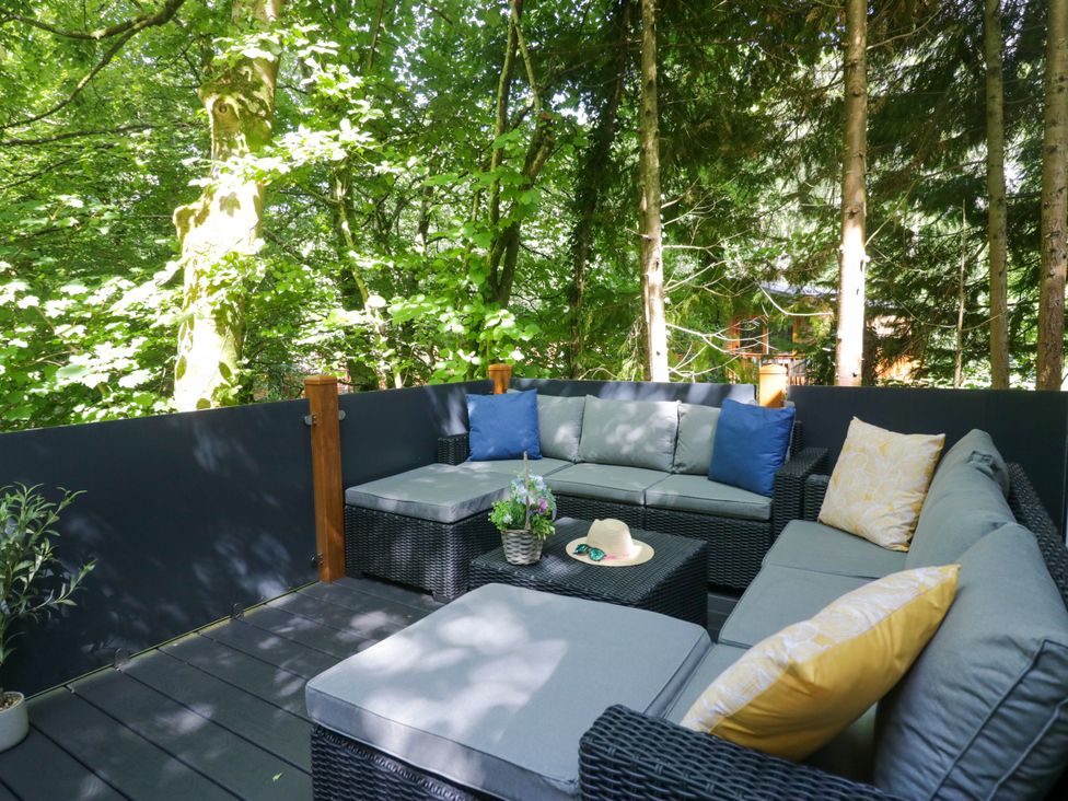 An outdoor seating area with a sofa and coffee table at Feather Hill Lodge White Cross Bay, Skiptory Howe 38