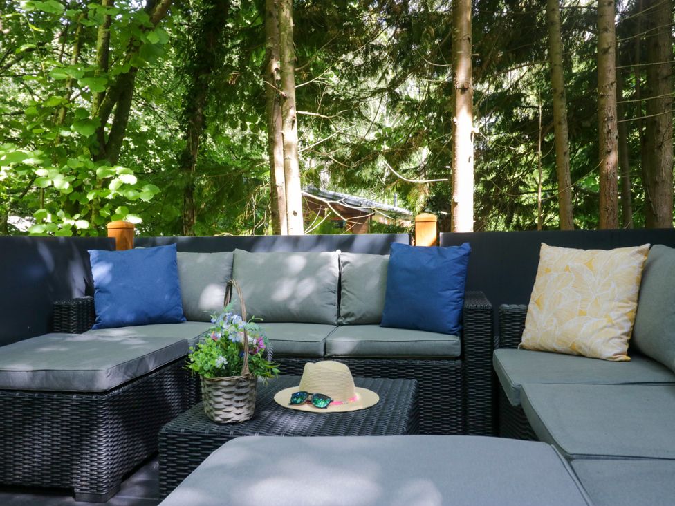 An outdoor seating area with a sofa and table at Feather Hill Lodge White Cross Bay, Skiptory Howe 38