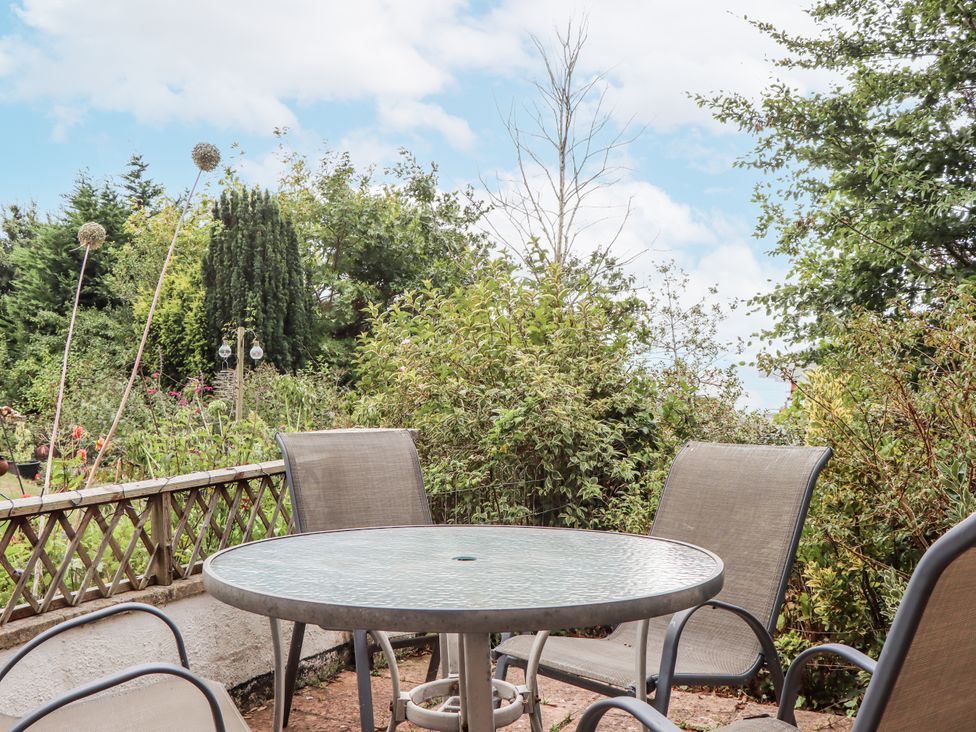 A garden with a table and chairs at Mayflower View, Dawlish