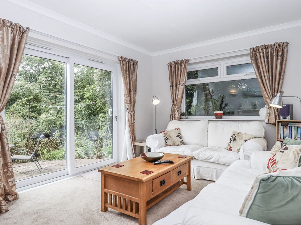 A living room with a sofa and coffee table at Mayflower View in Dawlish
