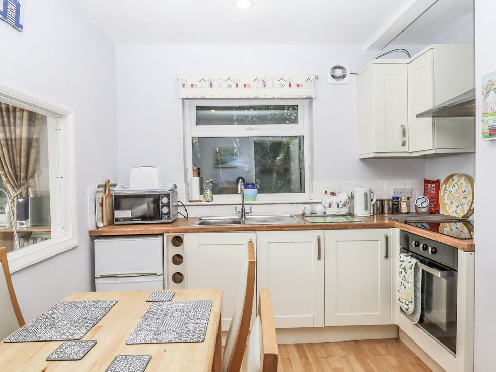 A kitchen with a table and chairs at Mayflower View in Dawlish
