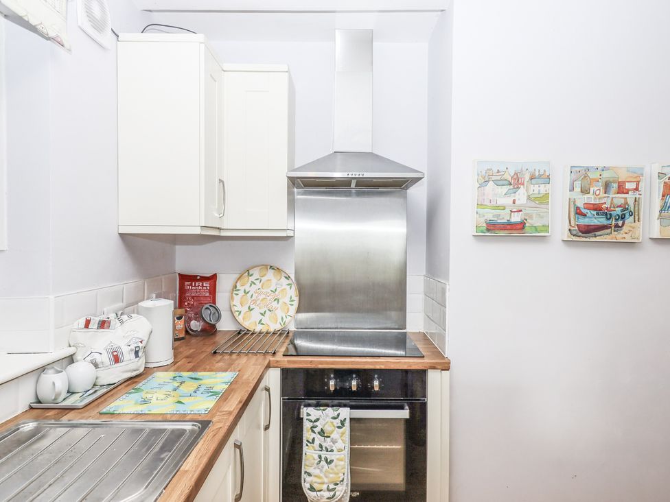 A kitchen with an oven and extractor hood at Mayflower View in Dawlish