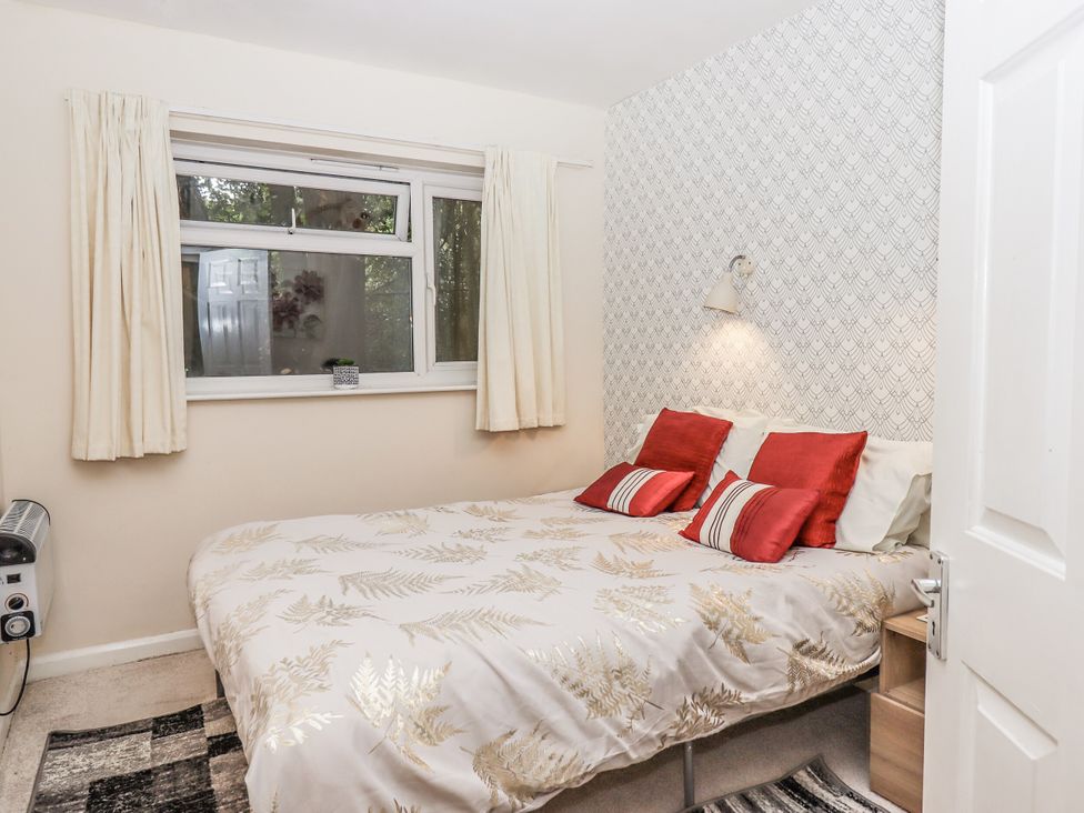 A bedroom with a bed and window at Mayflower View in Dawlish