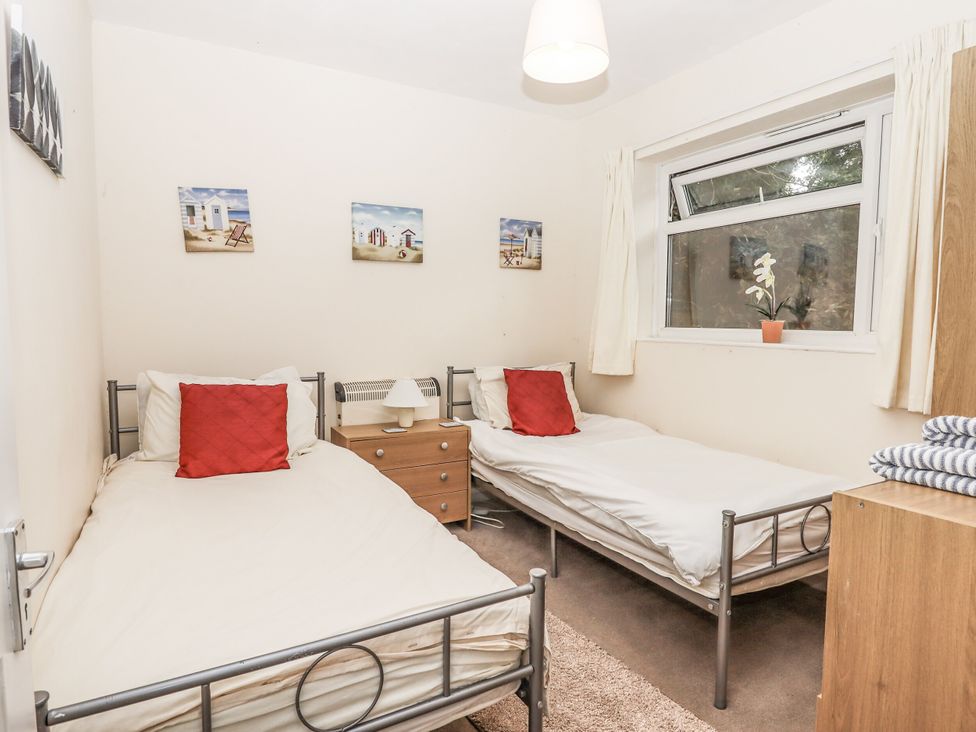 A bedroom with two single beds and a window at Mayflower View in Dawlish