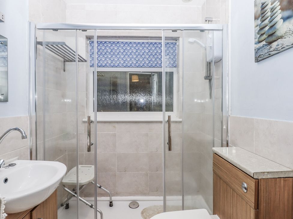 A bathroom with a shower and sink at Mayflower View in Dawlish