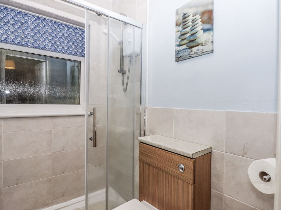 A bathroom with a shower and sink at Mayflower View in Dawlish
