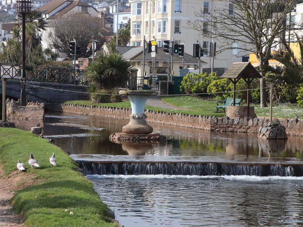A park with a fountain and pathway at Mayflower View in Dawlish