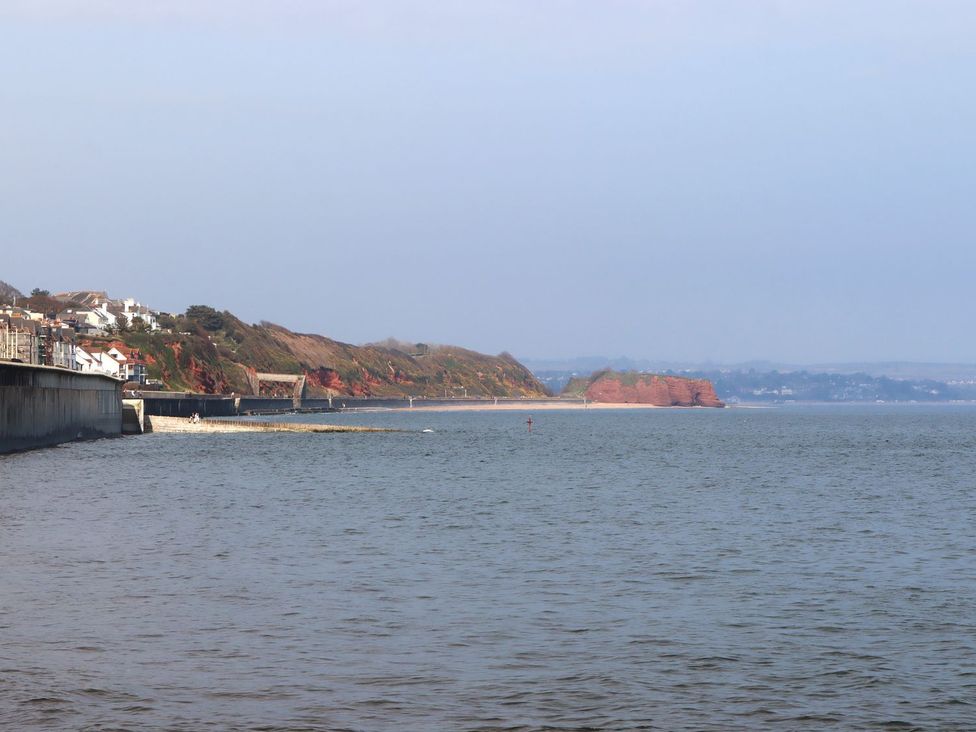 A beach landscape with cliffs and houses at Mayflower View in Dawlish