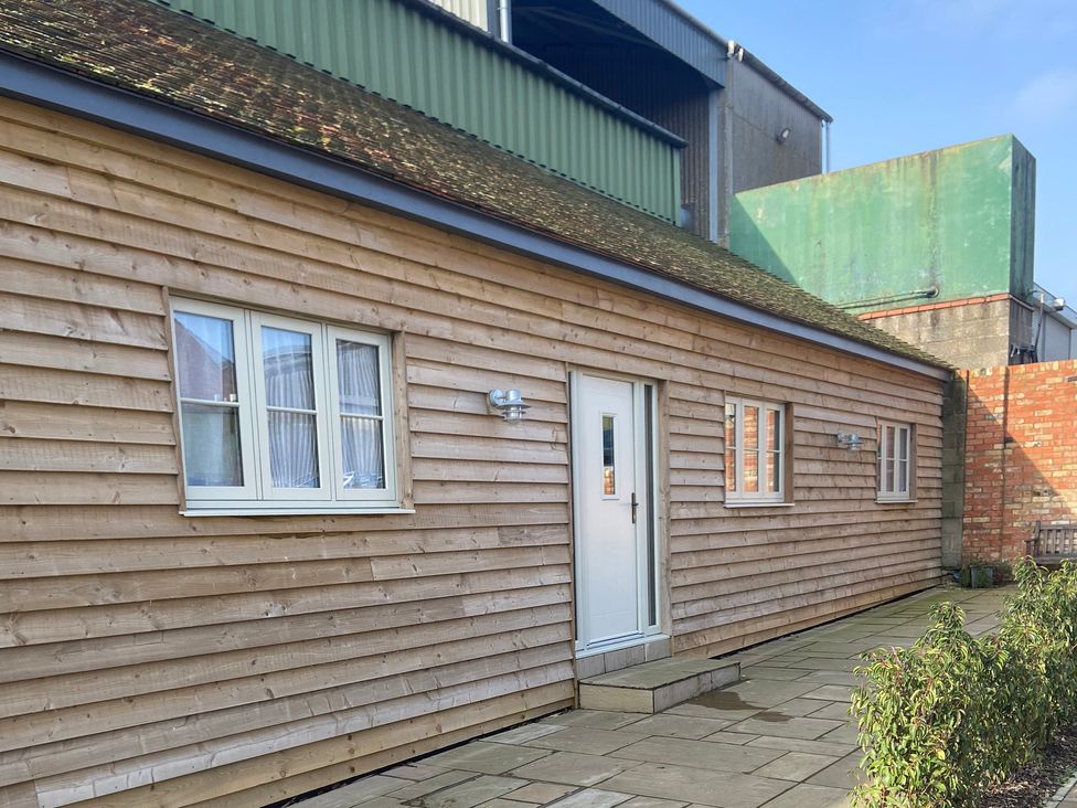 An exterior view of a wooden building at The Cart Shed in Bedford