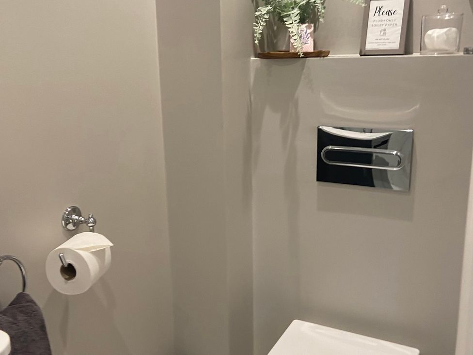 A bathroom with toilet and towel rack at The Cart Shed in Bedford