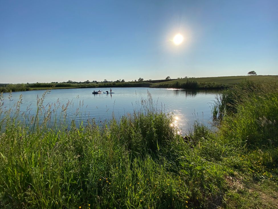 A pond with people in a canoe at The Cart Shed in Bedford