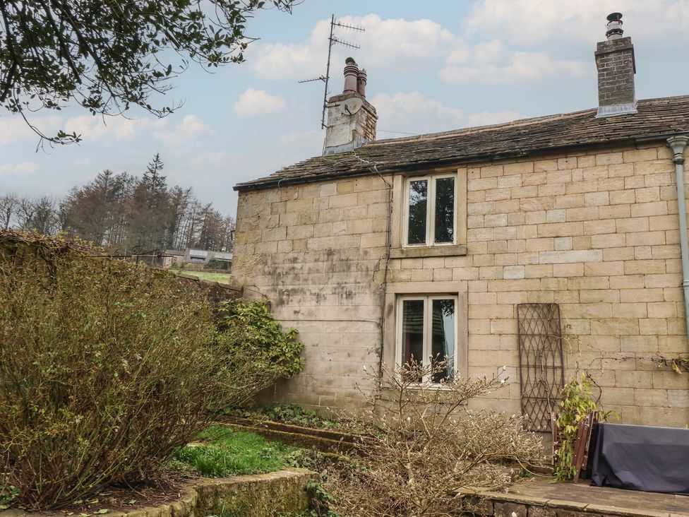 A cottage exterior with garden and gravel path at Wood End Farm Cottage