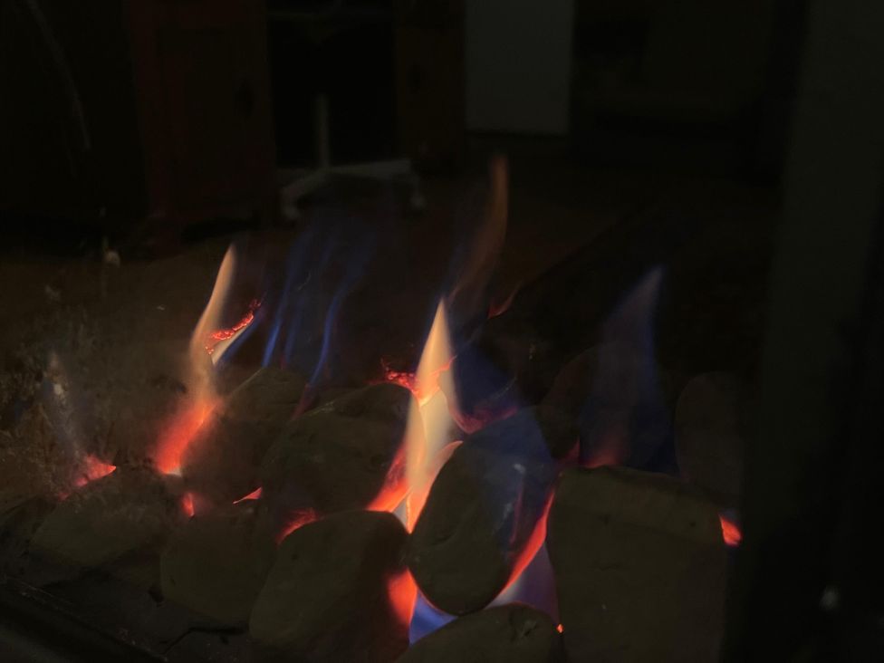 A fireplace with flames and rocks at 15A Currier Lane Ashton-under-Lyne