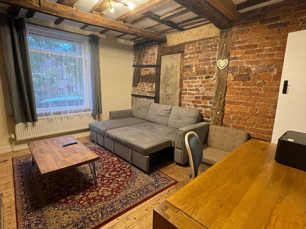 A living room with a sofa and coffee table at 15A Currier Lane Ashton-under-Lyne