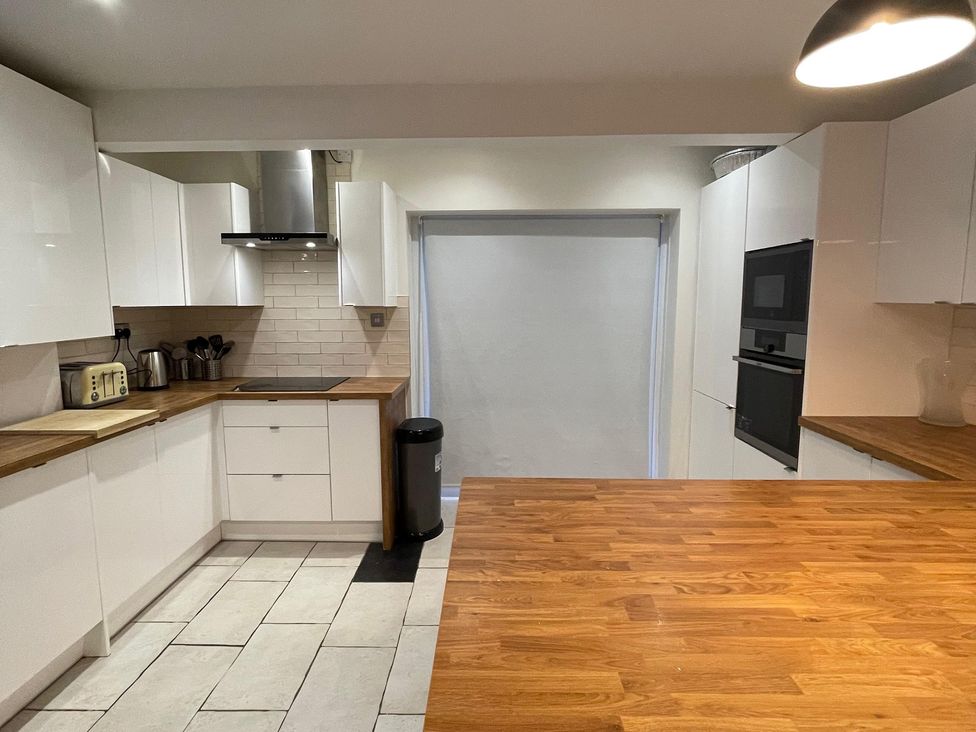 A kitchen with cabinets and countertop at 15A Currier Lane Ashton-under-Lyne
