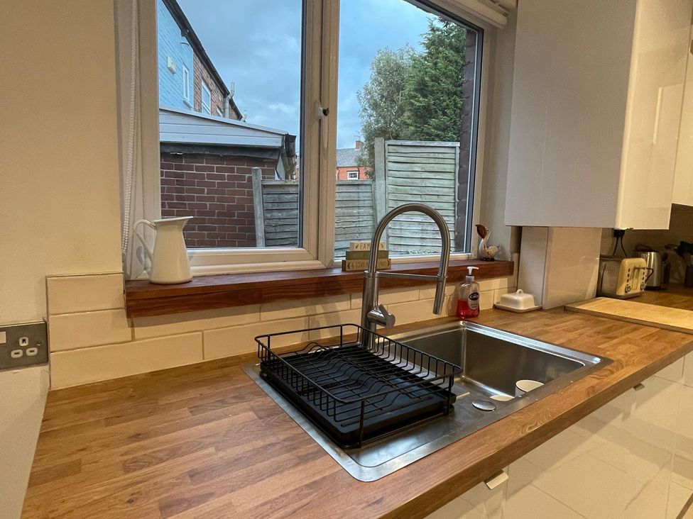 A kitchen with a sink and window at 15A Currier Lane Ashton-under-Lyne