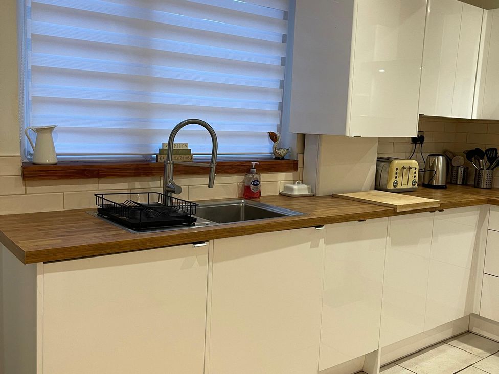 A kitchen with a sink and drying rack at 15A Currier Lane in Ashton-under-Lyne
