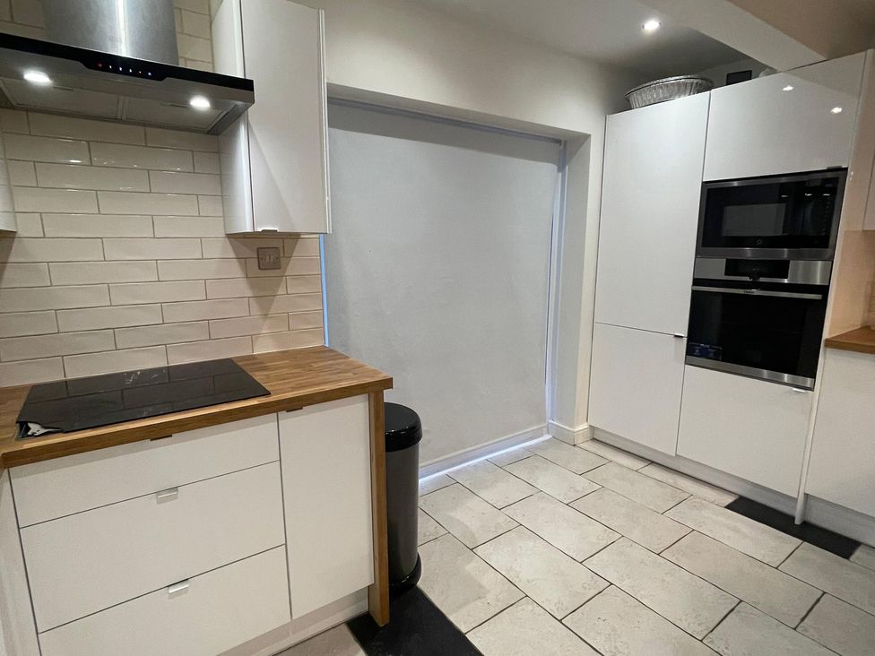 A kitchen with a stove and cabinets at 15A Currier Lane Ashton-under-Lyne
