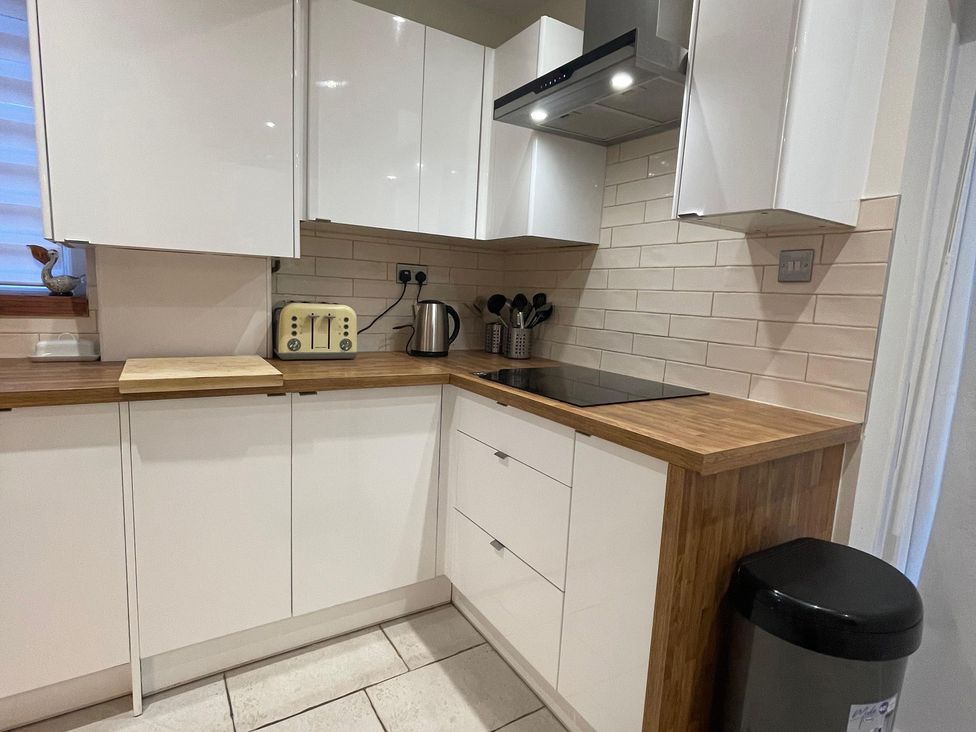 A kitchen with cabinets, a toaster, and a kettle at 15A Currier Lane Ashton-under-Lyne