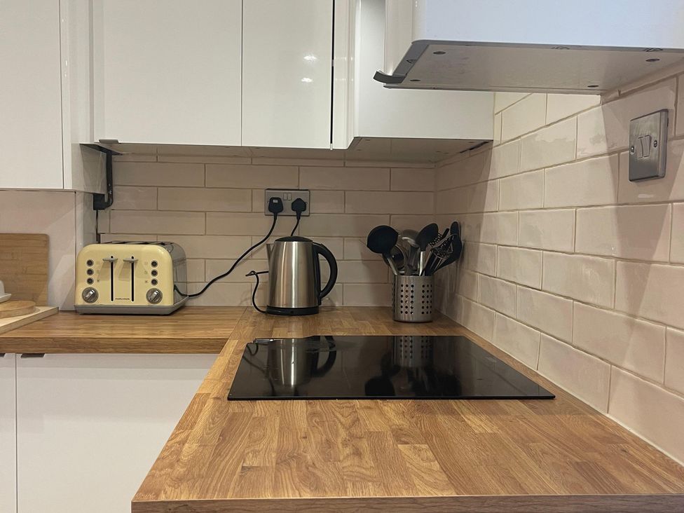 A kitchen with a kettle and toaster on the counter at 15A Currier Lane Ashton-under-Lyne